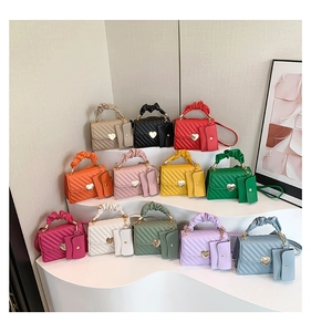 Detail of colorful quilted mini bags with heart-shaped metal twist locks and matching charms