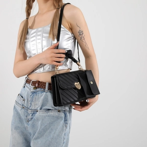 Chic black quilted PU leather crossbody bag featuring a golden heart swivel buckle closure