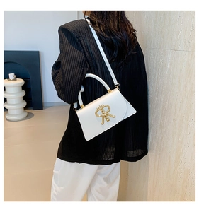 Detail of a white leather crossbody bag featuring a gold metal RR logo buckle for women