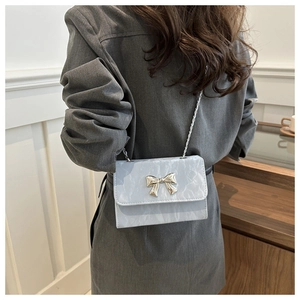 Blue marble textured chain shoulder bag with a silver metallic bow detail