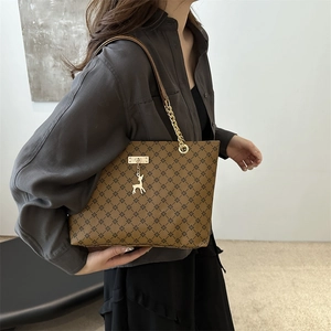 Retro brown tote bag with geometric print and gold deer charm on a shoulder chain strap