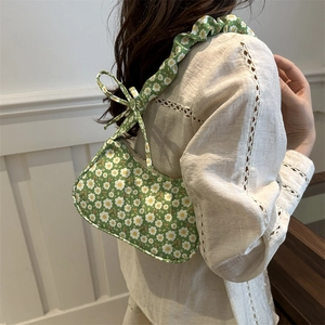 Green floral hobo bag with white daisy print and pleated bow shoulder strap