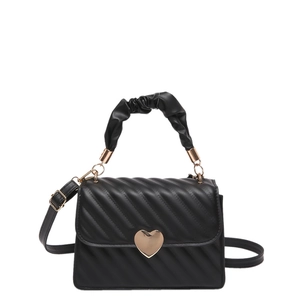 Minimalist black quilted shoulder bag with golden heart clasp and ruffled top handle