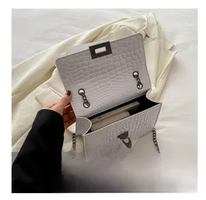 Internal view of white faux leather crossbody bag with chain and spacious compartment