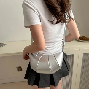 Silver crescent dumpling bag with pleated faux leather design and adjustable strap
