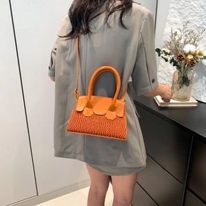 Orange textured woven crossbody bag for women featuring a stylish trapezoid design