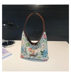 Close-up of floral jacquard hobo bag showing woven texture and brown leather details