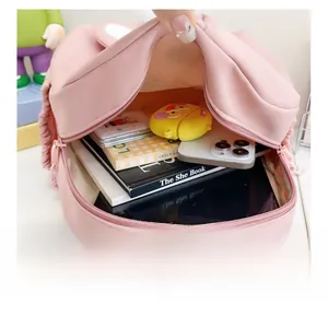 Pink waterproof nylon backpack showing large interior capacity for tablets and books