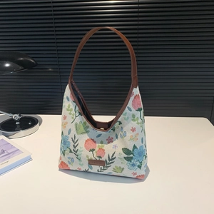 Retro canvas tote bag with colorful floral embroidery and brown leather shoulder strap