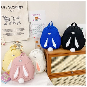 Detail showing five colors of cute cartoon rabbit backpacks with 3D ears and plush tails