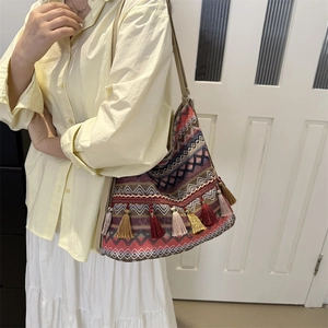 Ethnic bohemian woven tote bag with colorful geometric patterns and decorative tassels