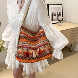 Bohemian style woven tote bag with geometric patterns and colorful tassels