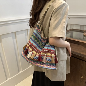 Bohemian woven tote bag with colorful geometric patterns and decorative tassels