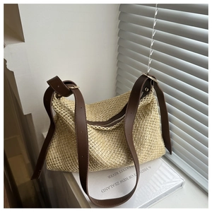 Chic beige woven straw crossbody bag with dark brown leather strap and metal buckle
