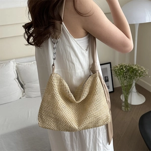 Woven straw tote bag with chain strap and hollow knit design for summer beach travel