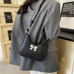 Fashionable black woven crescent underarm bag with silver bow buckle and adjustable strap