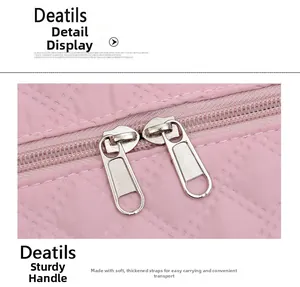 Detailed view of pink gym bag featuring thick webbing handles and durable dual metal zippers
