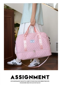 Pink quilted fitness bag with a separate bottom shoe compartment and shoulder strap