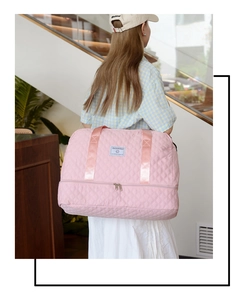 Pink quilted travel bag featuring a double-layer design and separate shoe compartment