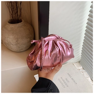 Macro detail of the pleated metallic pink clutch bag with fine drawstring shoulder strap