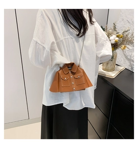 Unique jacket-shaped brown leather crossbody bag with chain strap on white shirt