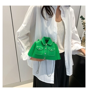 Green shirt-shaped shoulder bag with silver chain strap worn by a model