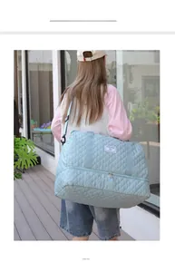 Detailed back view of a quilted light blue travel bag with an independent shoe compartment