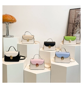 Six multi-colored PU leather crossbody bags with metal locks on geometric stands