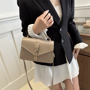 Elegant beige vintage flap handbag with golden oval buckle for crossbody or hand carry