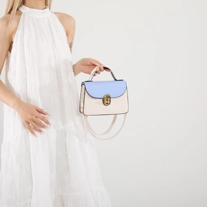 Blue and cream leather crossbody bag with gold twist lock and elegant top handle strap