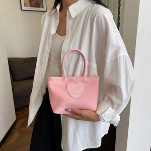 Pink nylon bucket handbag for women featuring a heart smiley patch and dual handles