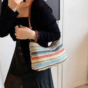 Colorful striped straw shoulder bag with brown leather straps for summer beach vacation