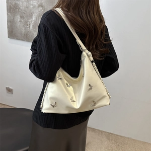 Cream butterfly tote bag with silver metallic accents shown from a rear back view