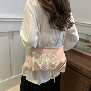 Pink satin crossbody bag with white floral embroidery and tassel in New Chinese style