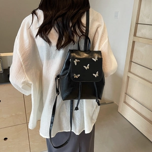 Mini black PU leather backpack for women featuring stylish silver butterfly metal accents