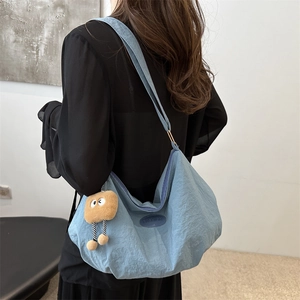 Chic light blue hobo shoulder bag with fashion patch and a cute plush bear charm