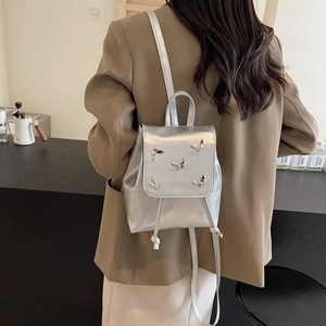 Silver fashion backpack with 3D metal butterfly ornaments and flap closure for women