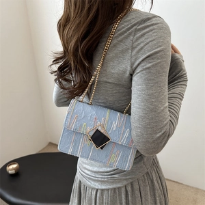 Minimalist light blue chain shoulder bag with wave embroidery and gold-tone clasp