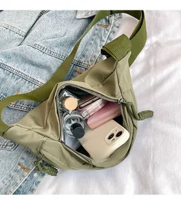 Spacious main compartment of army green nylon cross-body bag showing organized storage