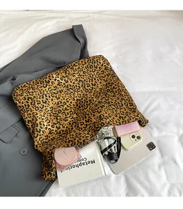 Detailed interior view showing large capacity of leopard print tote bag with daily items
