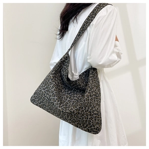Side view of large leopard print canvas tote bag showing soft hobo shape and drape