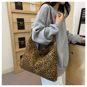 Close-up of stylish leopard print tote bag with wide shoulder strap for casual wear