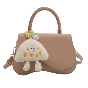 Elegant beige crossbody bag with unique curved base and cute mushroom charm detail