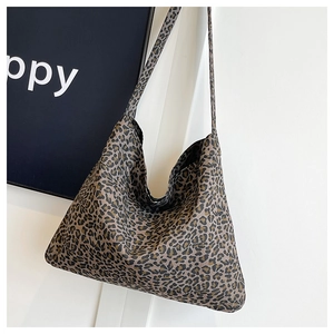 Macro detail of leopard print tote bag with soft texture and long shoulder strap