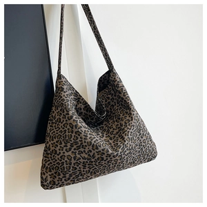 Detail of trendy leopard print tote bag showing thick canvas texture and wide shoulder strap