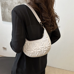 White textured crescent moon shoulder bag featuring geometric embossed faux leather