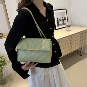 Minimalist light green quilted crossbody bag with golden chain strap and V-pattern finish