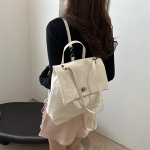 Minimalist beige wrinkled leather backpack for women with silver metal twist lock closure