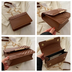 Detail view of brown quilted crossbody bag showing interior capacity and golden metal chain