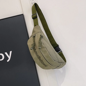Detail of army green nylon chest bag featuring urban utility style and textured fabric